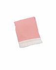 Pink cotton baby blanket with tassel trim, soft breathable newborn blanket for cot, stroller and nursery use.