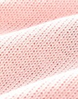 Soft cotton knit fabric texture of pink baby romper highlighting breathable material.