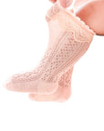Toddler wearing pink lace knit baby socks – cute and comfortable cotton ruffle knee socks.