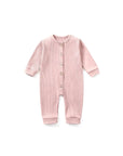 Soft pink ribbed cotton baby jumpsuit with button closure – gentle stretch knit for infants.