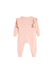 Back view of pink cotton knit baby jumpsuit showing delicate pattern and ruffle detail.