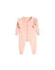 Front view of pink ruffle cotton knit baby jumpsuit with button closure and long sleeves.