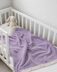Purple cotton baby blanket with tassel trim, soft breathable newborn blanket for cot, stroller and nursery use.