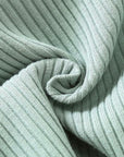 Soft ribbed cotton fabric texture used in baby jumpsuit – breathable and stretchable knit.