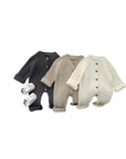 Three ribbed knit baby rompers in charcoal gray, khaki, and cream, long sleeve winter outfits
