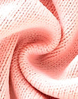 Close-up texture of soft pink knitted fabric for baby romper