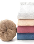 Stack of multi-color cotton baby socks showing thick and soft fabric texture