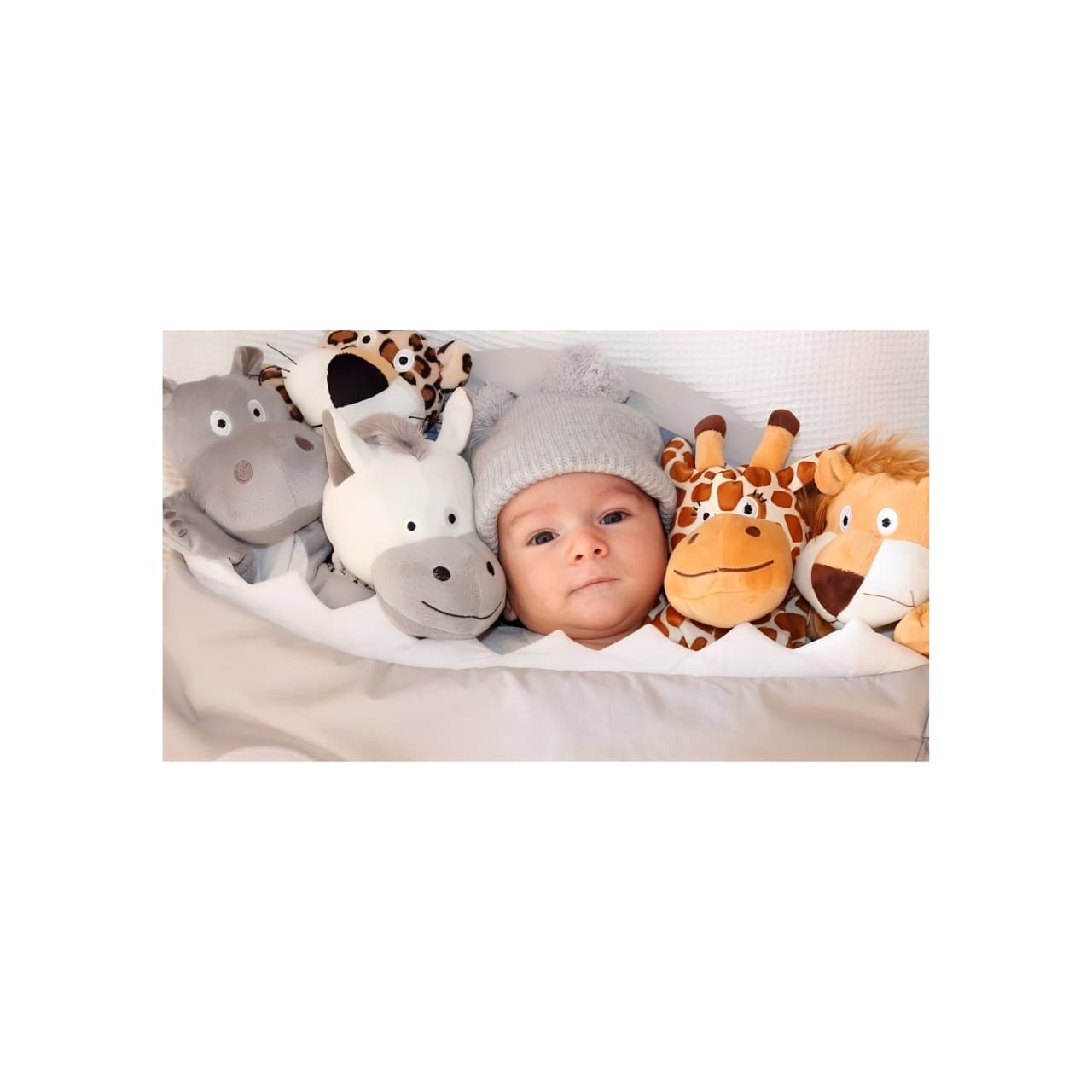Newborn baby with stuffed animal toys, thoughtful childbirth gift and baby keepsake idea.