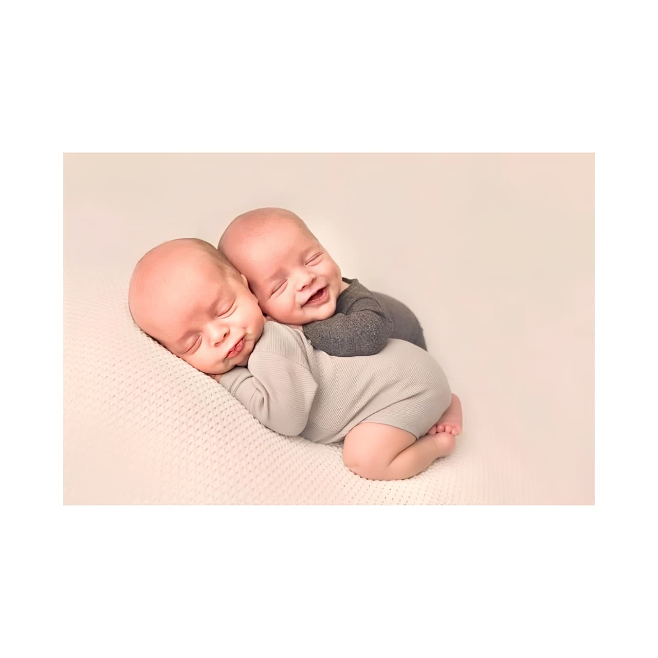 Newborn twin boys in neutral beige onesies, cozy newborn clothing gift set for baby shower present