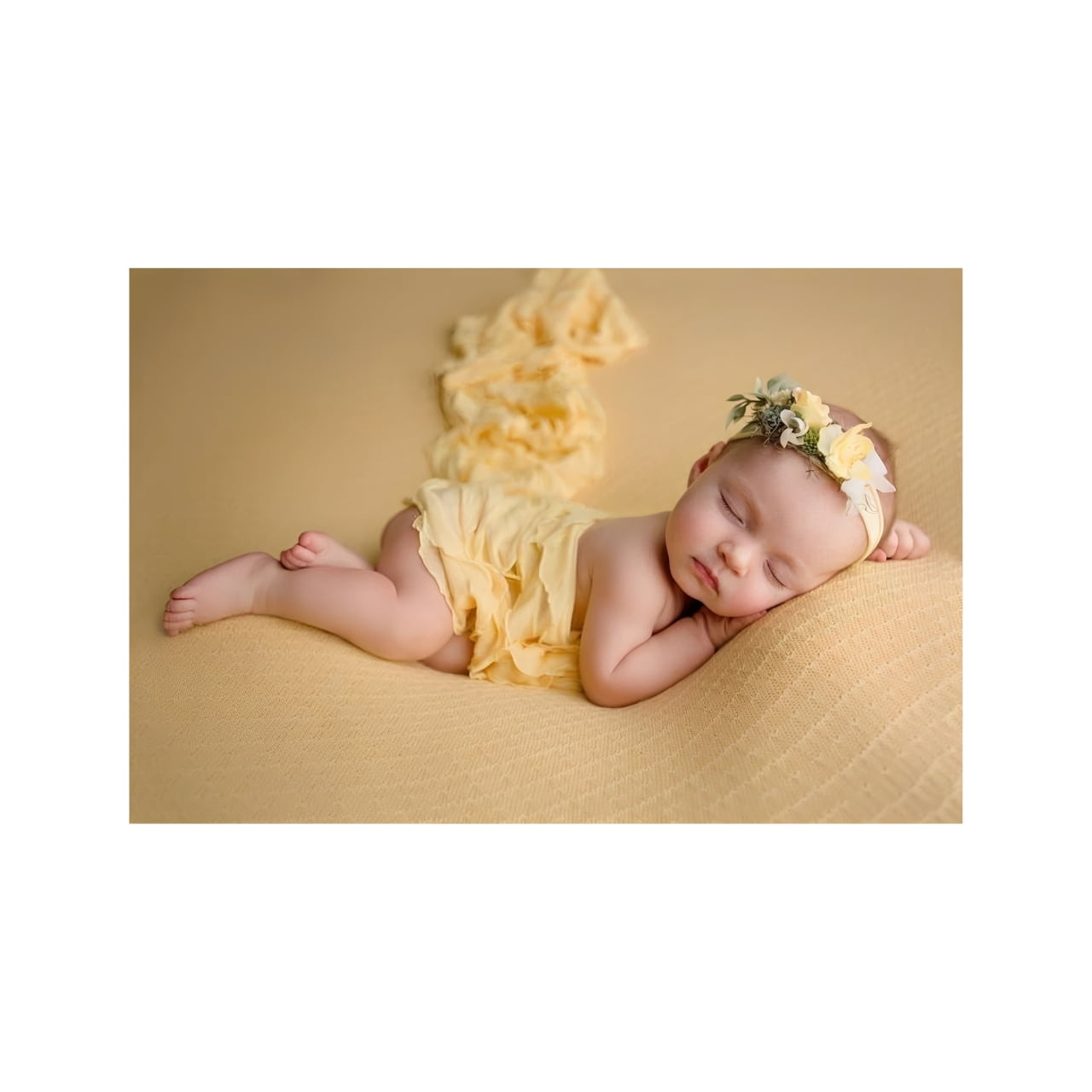 Newborn baby girl in yellow dress with floral headband, luxury baby gift inspiration