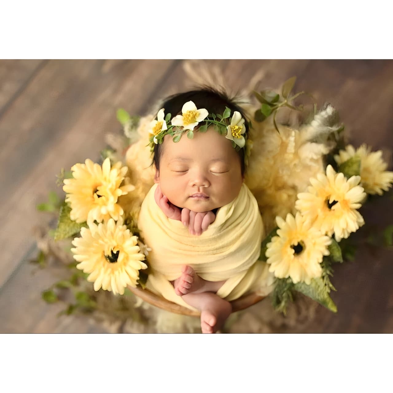 Newborn baby wrapped in yellow blanket surrounded by sunflowers, perfect niece gift idea for special occasions.