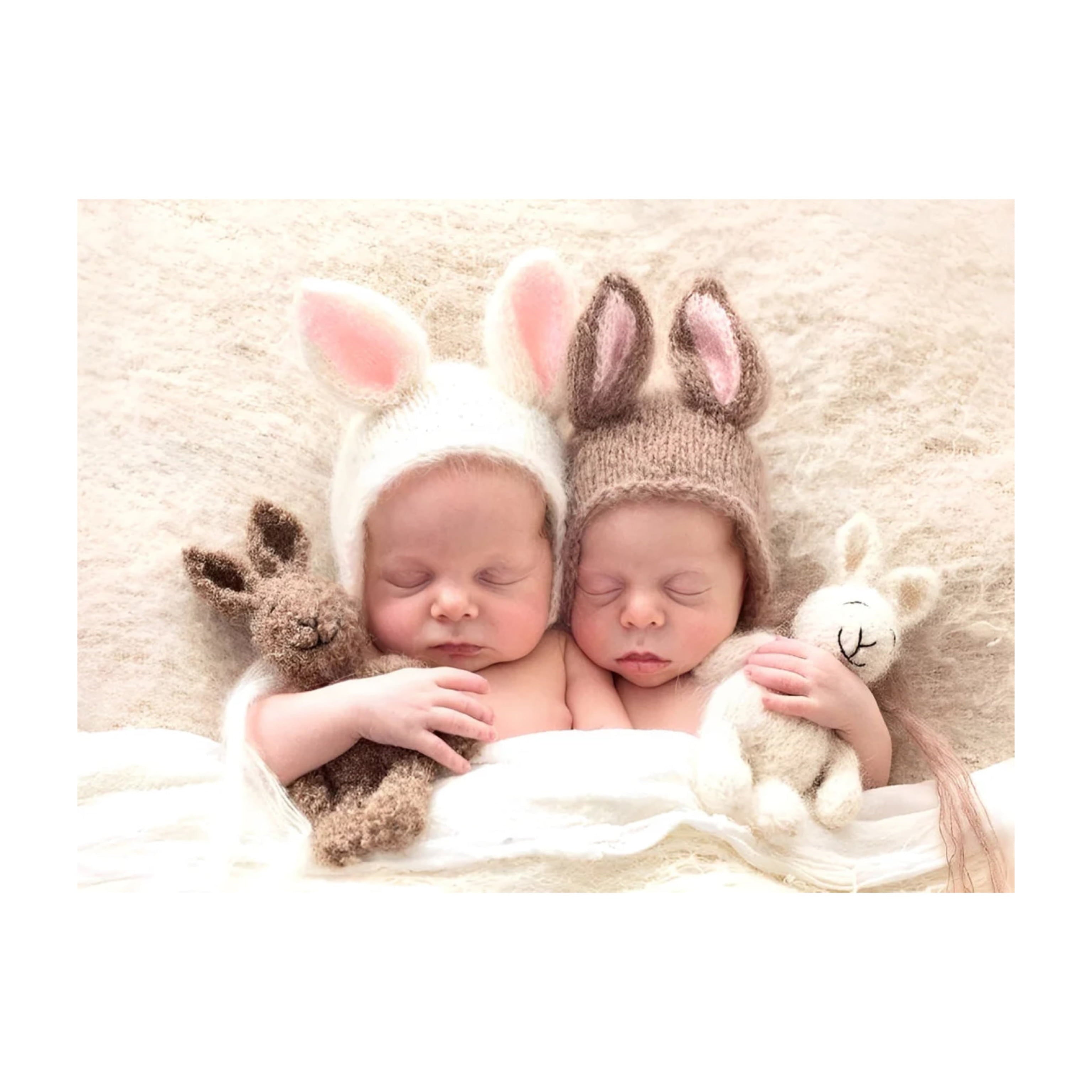 Newborn twin granddaughters wrapped in blankets wearing bunny ear hats, adorable keepsake baby gift idea.