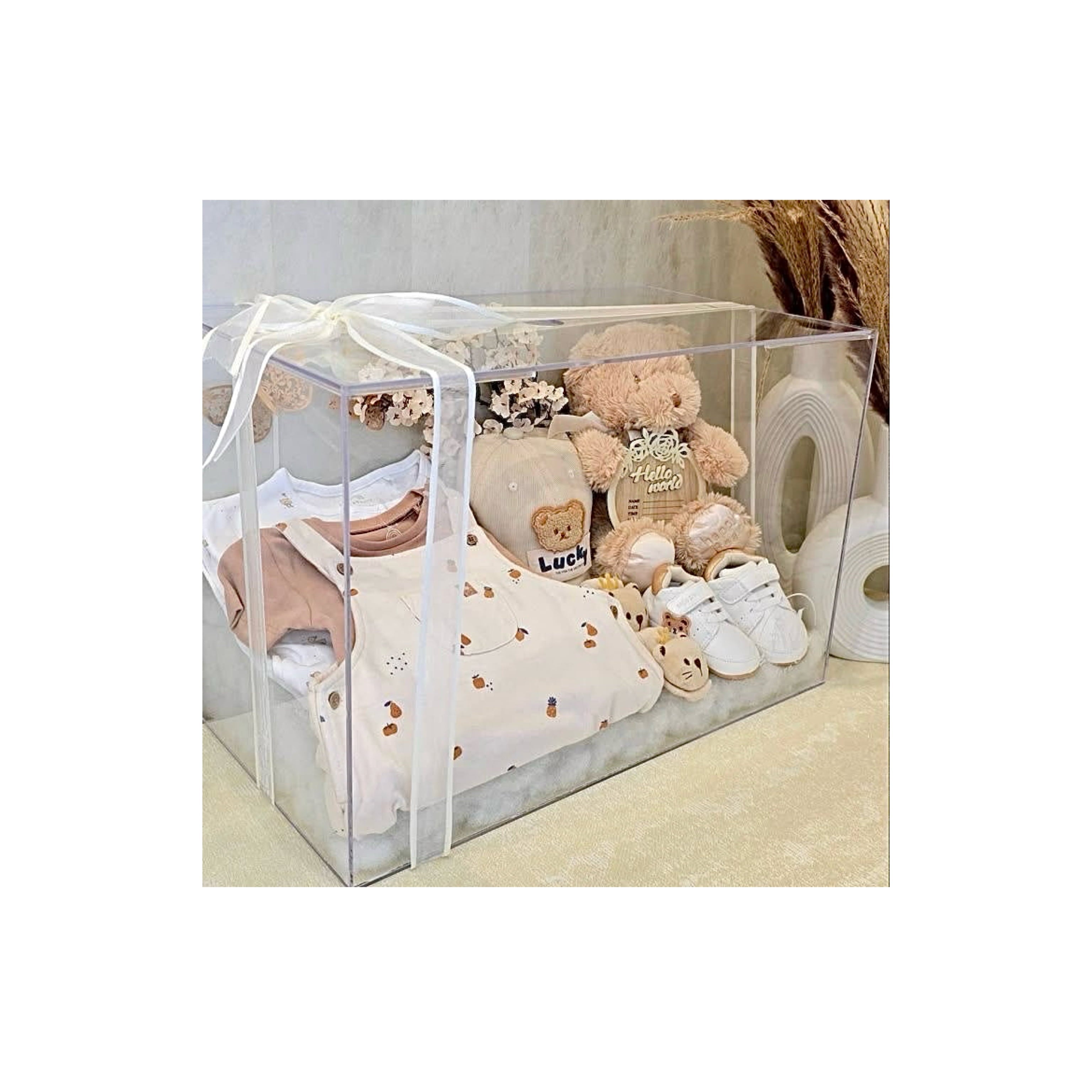 Newborn welcome gift set with baby clothes, blankets, and essentials, thoughtful baby shower gift bundle.