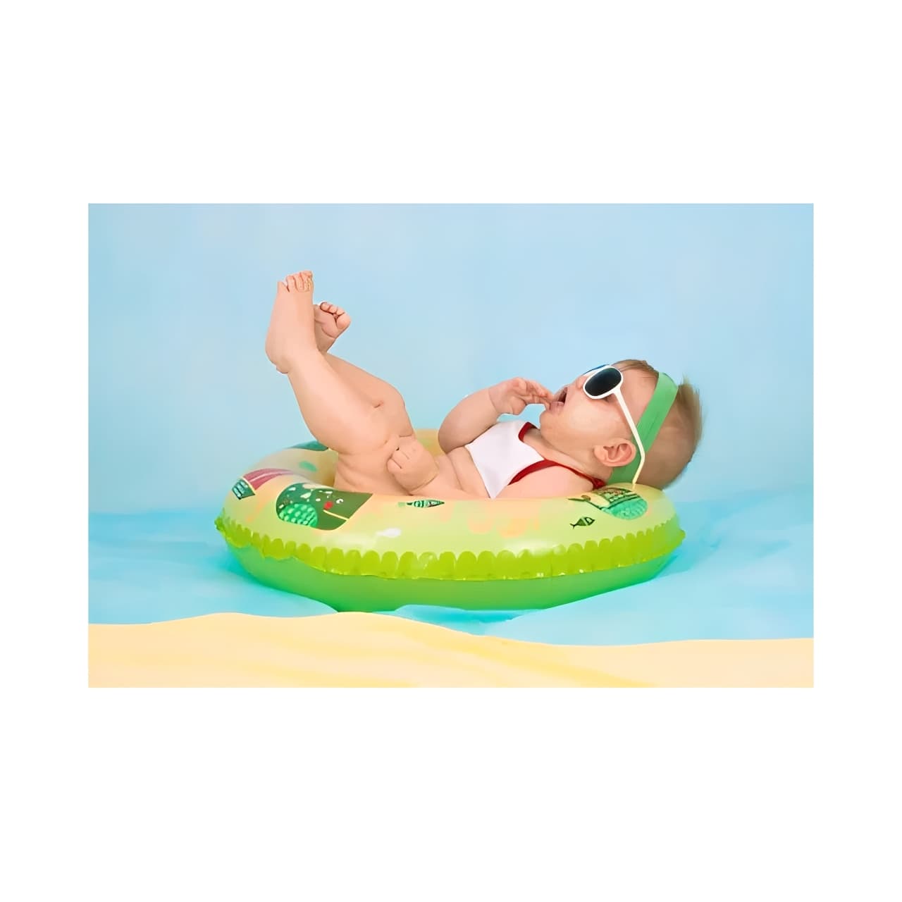 Cute baby on a beach float wearing sunglasses, perfect for summer-themed baby gift sets or holiday baby photos.