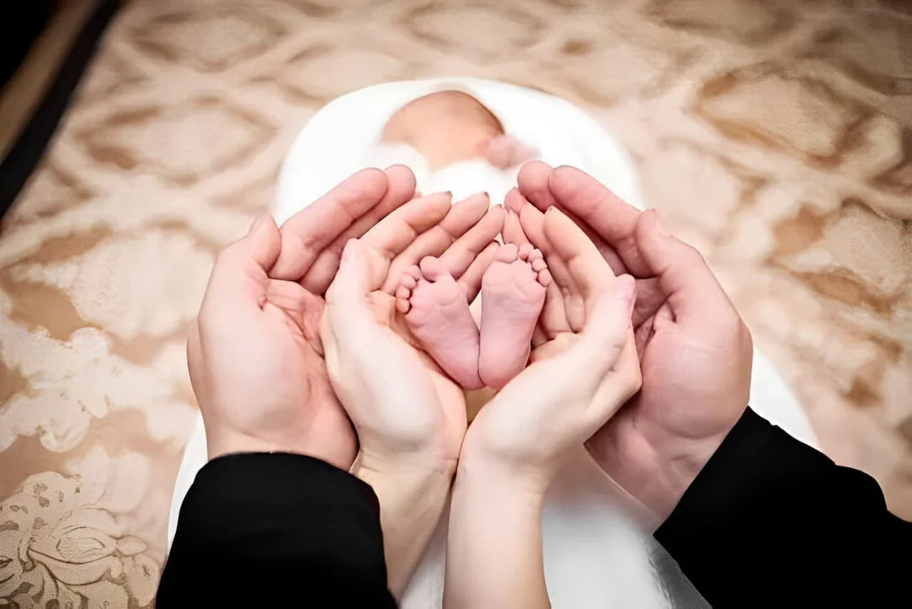 Heartwarming image of adult hands cradling a newborn’s feet—perfect visual for baby keepsake gifts and memory preservation themes.