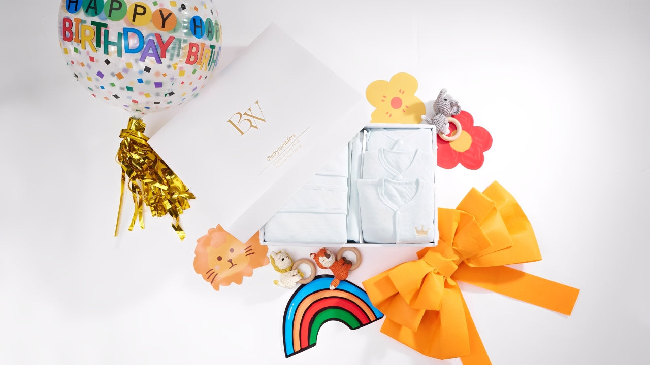 Festive baby gift set featuring coordinated storage boxes, soft toys, birthday balloon, and playful accessories — ideal for organising baby essentials and celebrating a special occasion.