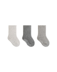 Three pairs of gray socks on a white background