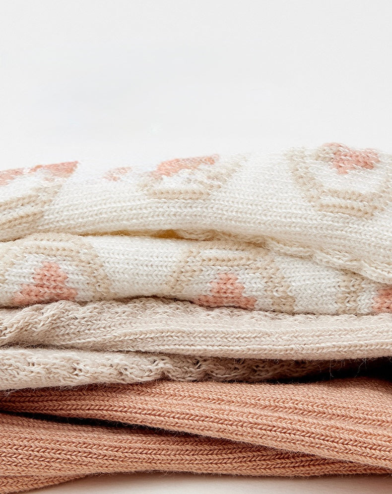 Stack of Australian cotton baby socks in neutral colors, soft breathable fabric layers.