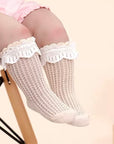Baby wearing beige lace mesh cotton socks, lightweight breathable socks for spring and summer comfort.