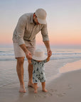 Baby wearing bird print zip swim romper on the beach, lightweight breathable baby swimwear for summer holidays