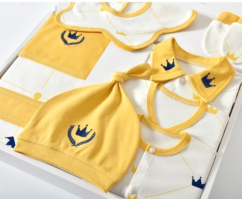 Baby clothing set with yellow bibs, hats, and shirts on a white background