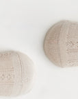 Soft beige baby cotton socks close-up showing fine knit texture and breathable fabric.