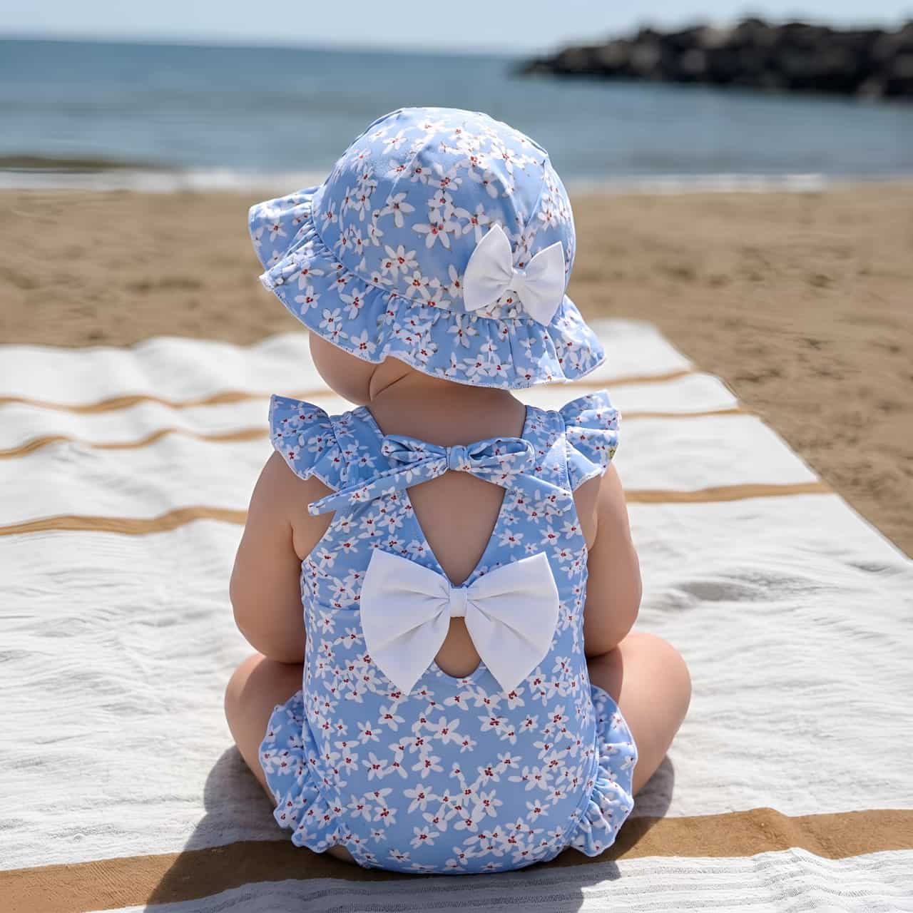 Baby girl wearing blue floral swimsuit with matching hat, soft breathable baby swimwear perfect for beach and summer holidays