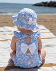Baby girl wearing blue floral swimsuit with matching hat, soft breathable baby swimwear perfect for beach and summer holidays