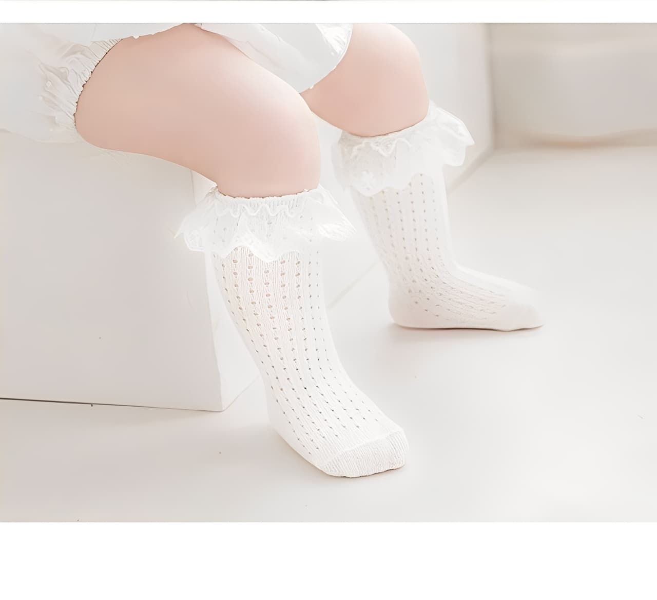 Toddler girl wearing white lace cotton knee-high socks with frilly trim, soft breathable design
