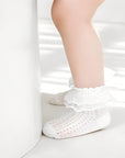 Baby wearing lace ruffle socks made of soft breathable cotton with frilled cuffs for comfort and style