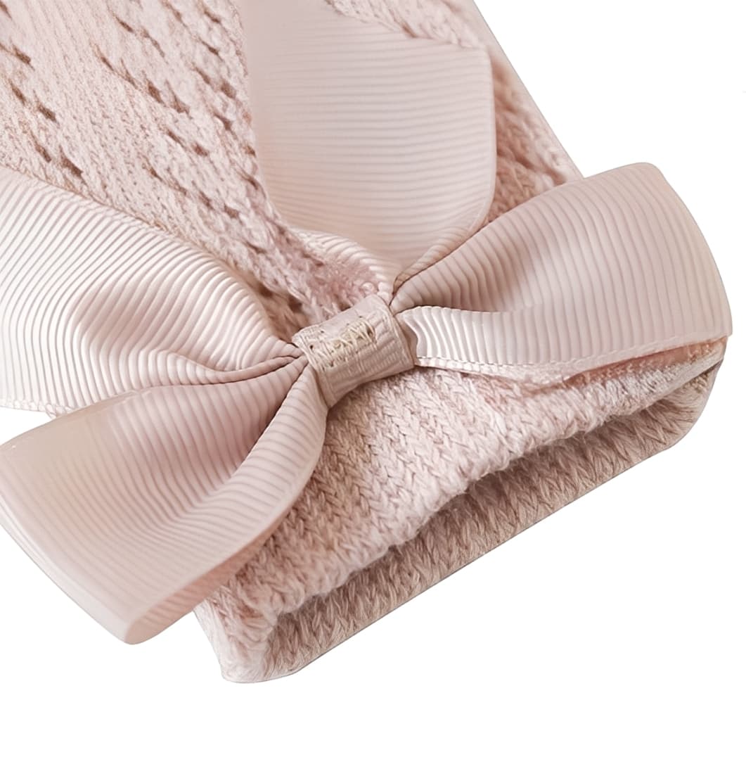 Close-up of pink grosgrain bow on baby lace knee-high socks, soft and stretchy cuff