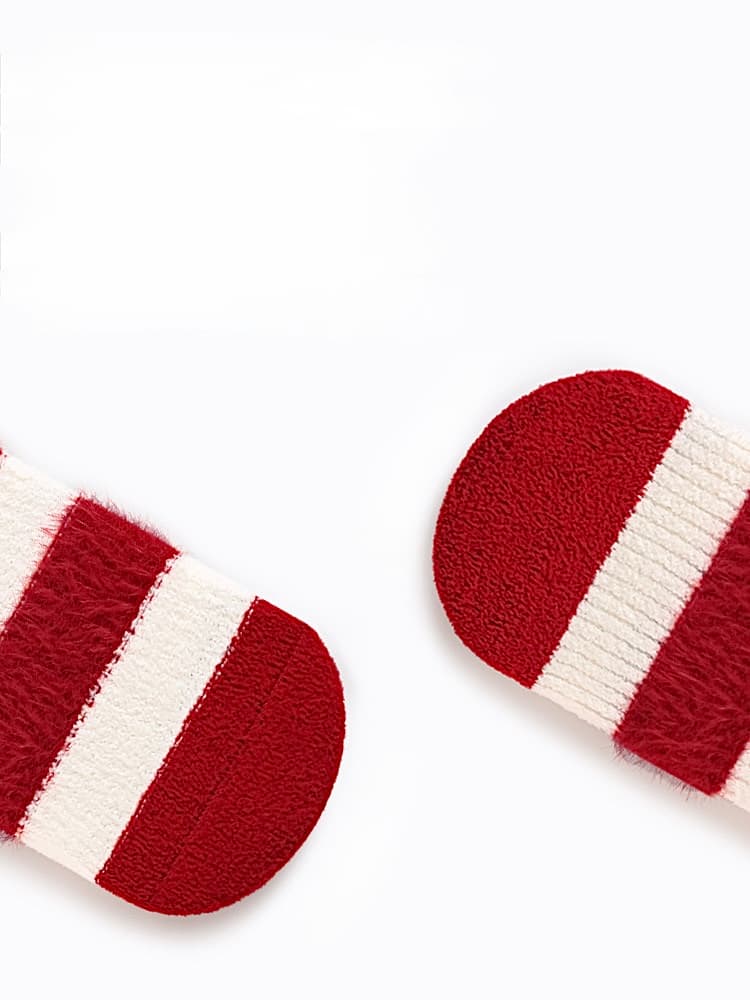 Close-up of soft red knit baby socks showing warm texture and high-quality fabric for newborns.
