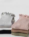 Set of six folded baby ruffle socks in neutral cotton colors, soft and breathable
