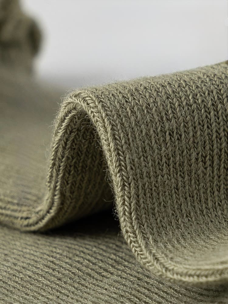 Soft long-staple cotton knit texture close-up showing breathable and durable