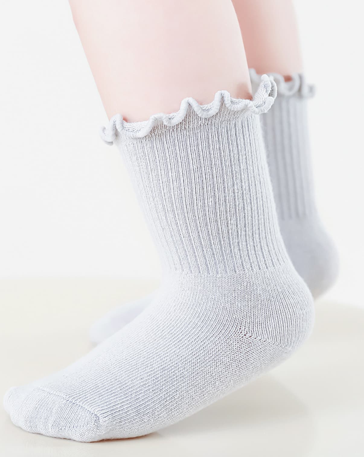 White ruffle baby socks made from soft combed cotton, perfect for sensitive skin
