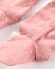 Close-up of pink baby cotton sleepsuit with footed design and popper fastening, soft breathable fabric
