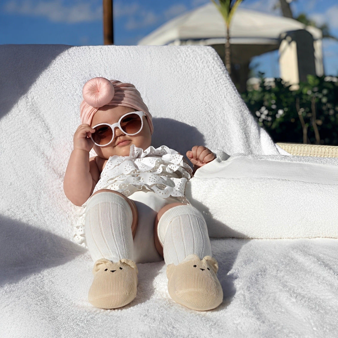 Baby girl wearing cream solid knee-high socks with cute bear detail and soft cotton comfort for toddlers and babies