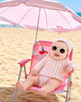 baby girl wearing pink striped long sleeve swimsuit with matching swim hat and sunglasses