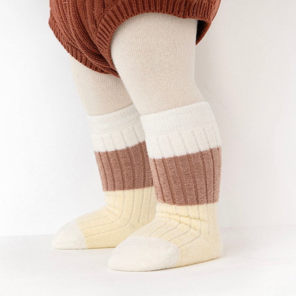 Baby wearing retro brown and cream striped ribbed socks – cozy winter outfit