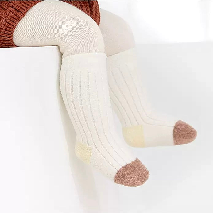 Baby wearing yellow and cream striped ribbed cotton socks – winter warm set