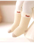 Baby wearing striped beige bear socks – soft breathable cotton comfort from BabyWonders UK