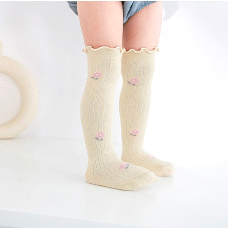 Baby wearing pastel yellow scalloped knee-high socks – soft cotton baby socks UK