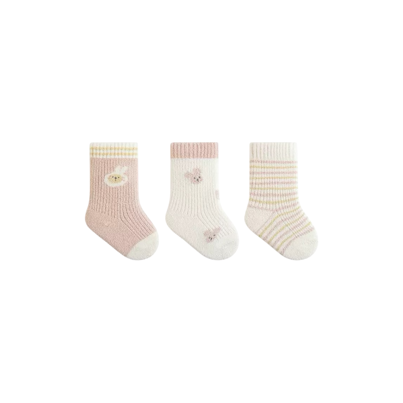 Three pairs of baby socks with decorative buttons on a white background