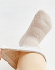 Soft beige cotton baby socks with comfortable stretch fit for infants.