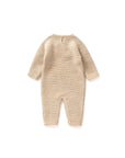Back view of beige knitted baby romper showing soft texture and button closure at neck