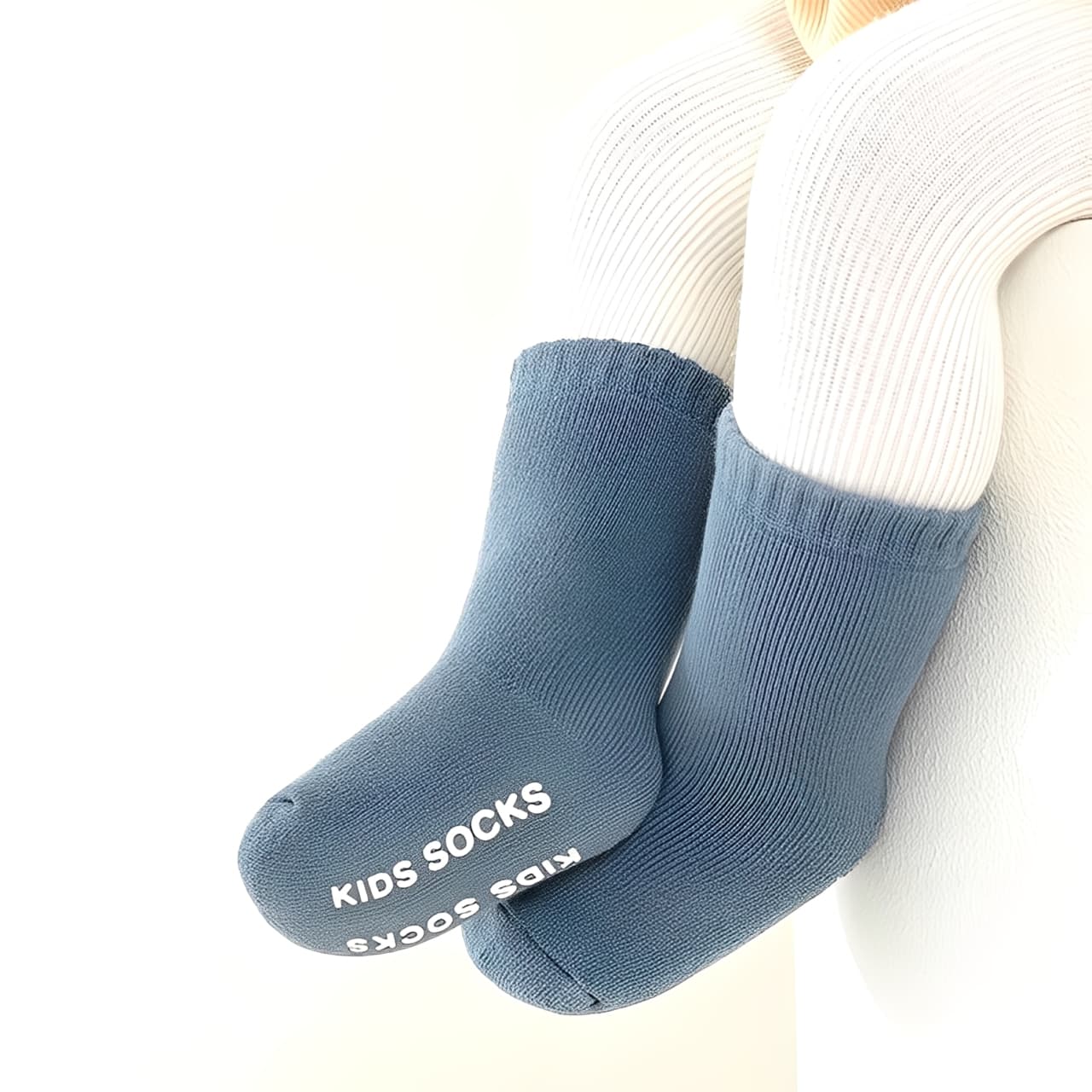 Baby wearing blue cotton anti-slip socks for warmth and comfort
