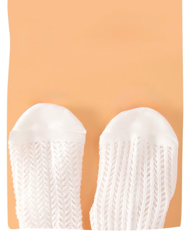 Durable reinforced toe area of lace knit baby socks made of premium cotton.