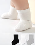 Baby wearing white cotton socks – soft and breathable everyday baby socks