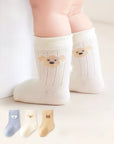 Baby wearing cream bear embroidered cotton socks – soft baby socks UK
