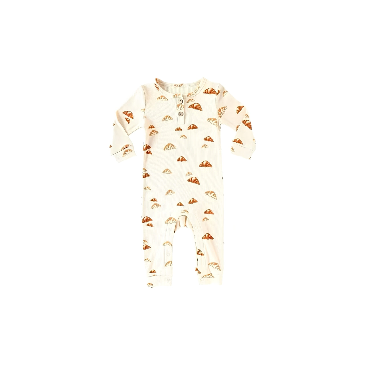 Cream cotton baby romper with brown croissant print, soft ribbed knit texture, long sleeves, and snap bottom for easy diaper changes.
